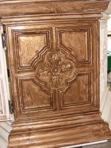 First part of the glazing process! My first thought when I slathered on the glaze was: "oh no! I just wiped mud all over my beautiful white paint!" I was REALLY nervous, but just chose to trust all the bloggers who instructed simply wiping it off. After looking at TONS of glazed furniture online, the technique I chose to follow was Mandi Gruber's "clean glazing" over at Vintage Revivals. I found her site while searching for how to make a headboard out of an old door (something I plan to do...I already have the door). Anyway, Step 1 is to paint the glaze on with a brush, paying special attention to all of the detail.